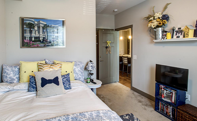 An apartment bedroom with attached bathroom.