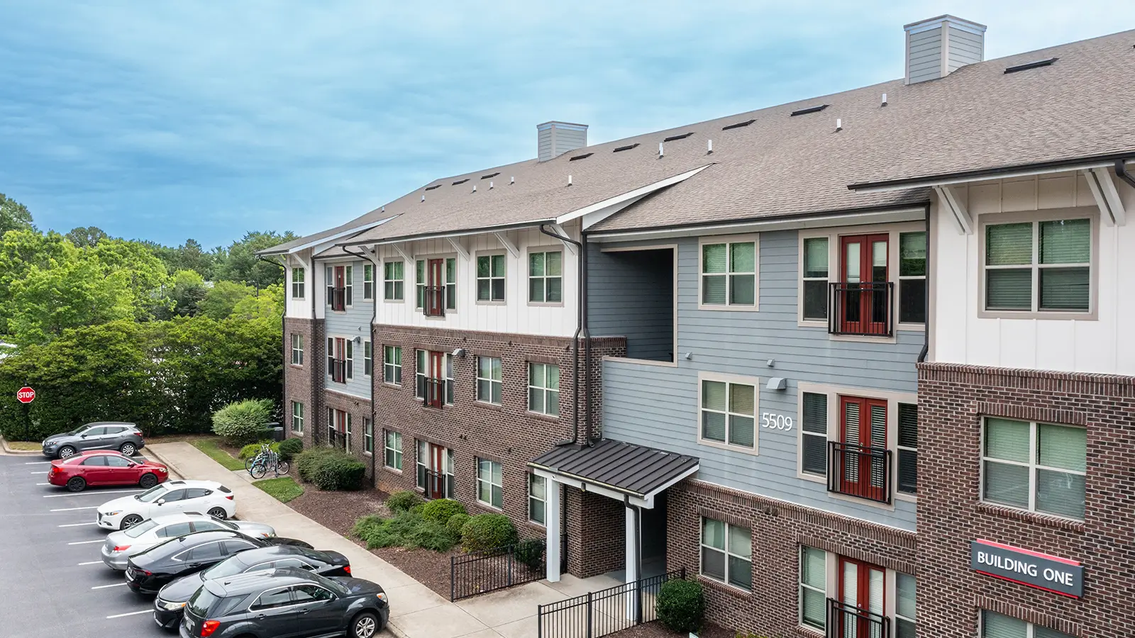Exterior of an apartment community, with surface barking and townhomes